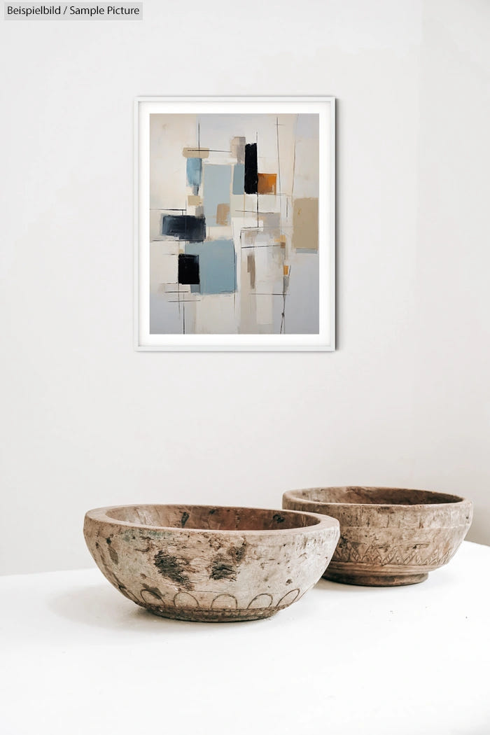 Abstract painting above rustic wooden bowls on white table.