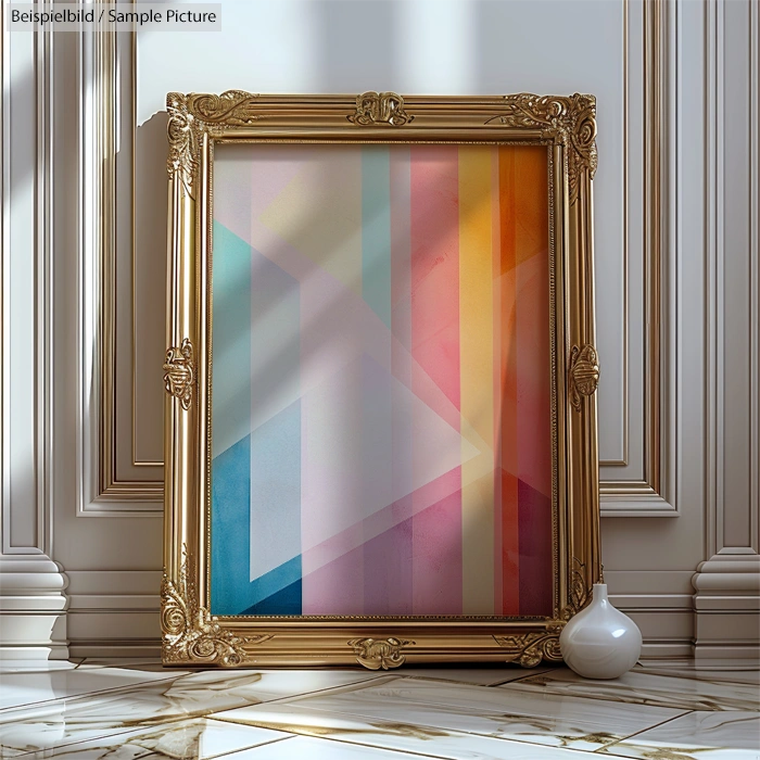 Framed geometric abstract painting with pastel shades of pink, blue, and orange, placed against an ornate white wall.