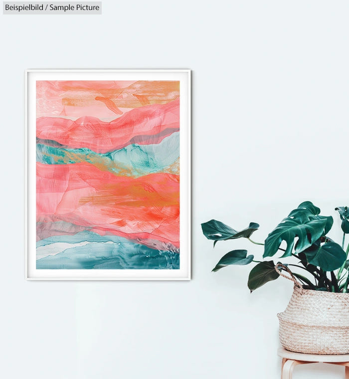 Abstract wall art with vibrant pink and blue hues, framed on a white wall next to a potted plant with large green leaves.