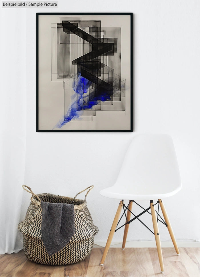 Abstract geometric artwork with black, gray, and blue elements in a frame above a modern chair and a woven basket.