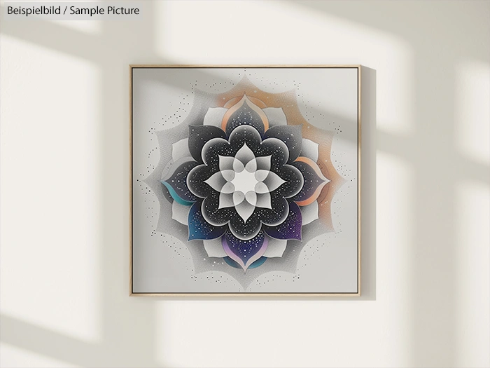 Mandala art with intricate design in black, white, and rainbow hues, displayed on a wall with shadow patterns.