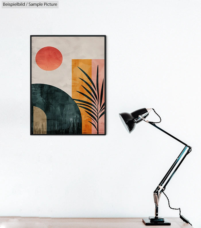 Modern abstract art with geometric shapes and a plant silhouette, framed on a wall, next to a black desk lamp.