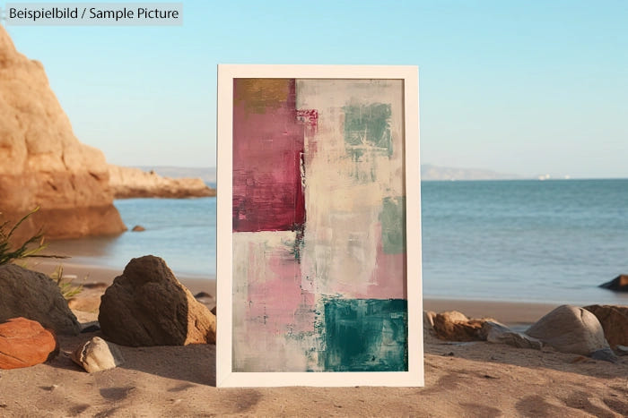 Abstract painting with pink, white, teal hues framed on a rocky beach with sea and cliffs in the background.