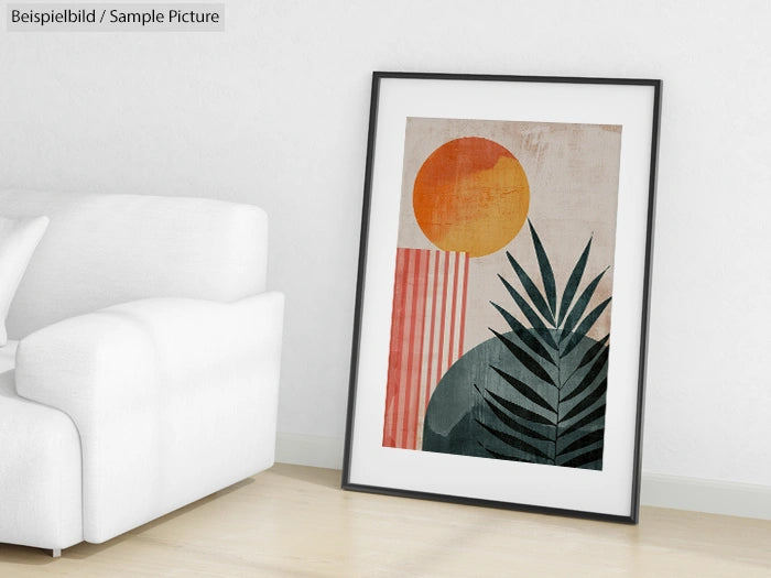 Framed abstract art with geometric shapes and plant on a floor near a white couch and wall.