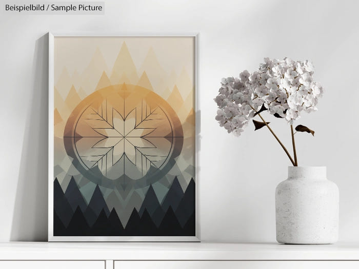 Framed abstract art with geometric mountains and floral design beside a white vase with white flowers on a shelf.