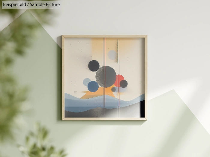 Minimalist geometric painting with circles and waves in a wooden frame on a light wall.