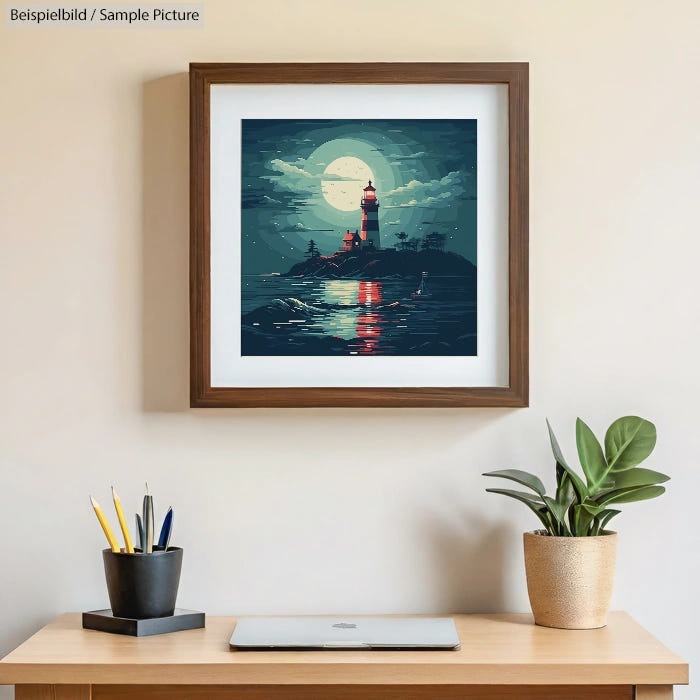 Framed painting of a lighthouse under a full moon, hanging above a desk with plant and pencil holder.