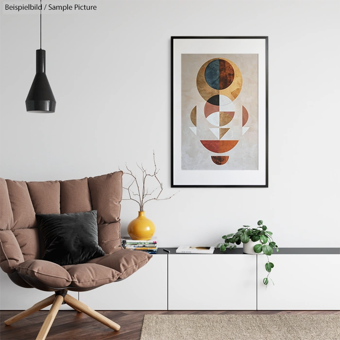 Modern living room with brown chair, abstract geometric artwork, black pendant light, and white cabinet with decor.