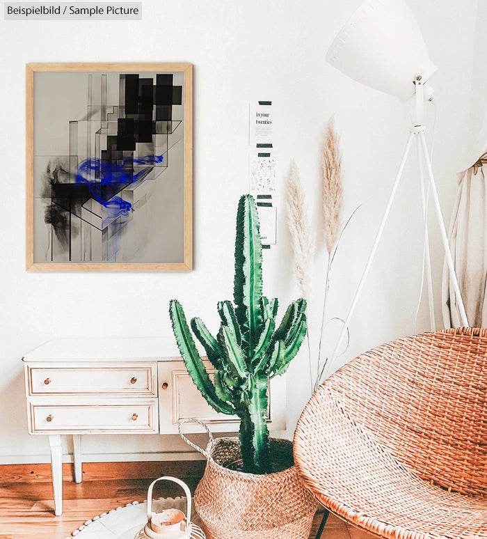 Modern living room with abstract art, cactus, wicker chair, and white furniture under soft lighting.