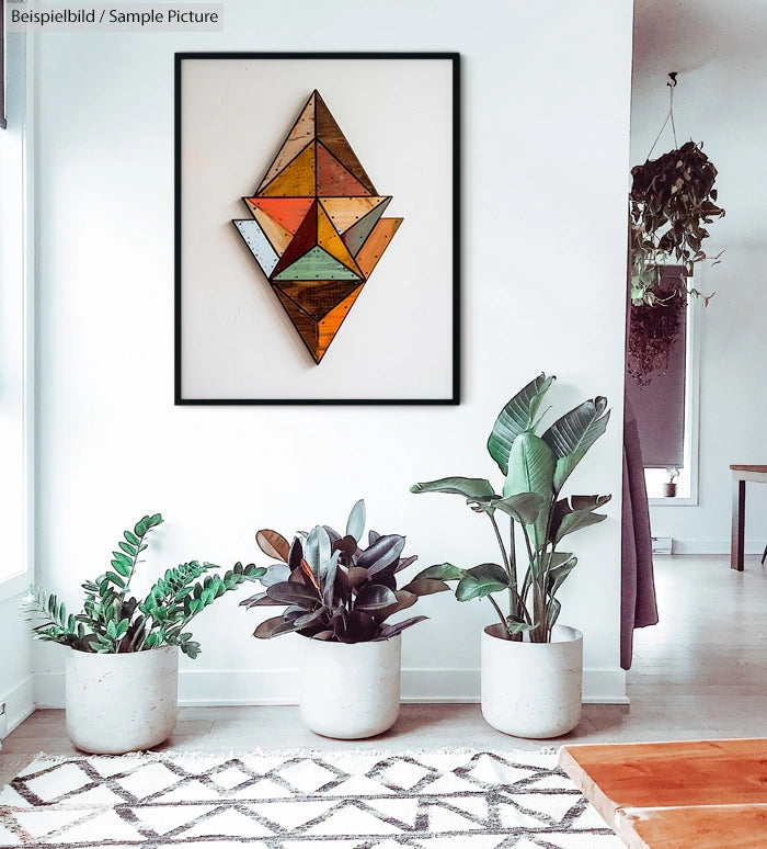 Modern living room with geometric wall art and potted plants on white walls.