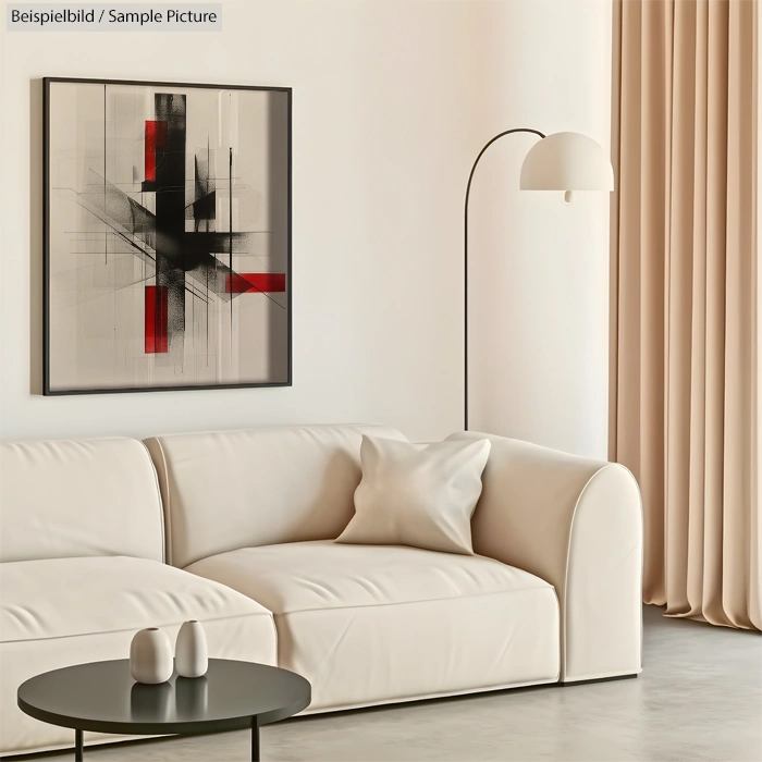 Modern living room with beige couch, black and red abstract art, floor lamp, and round coffee table in neutral tones.