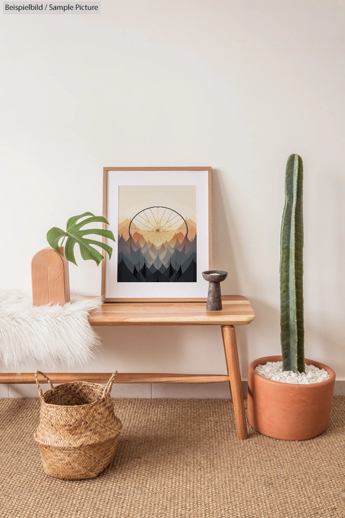 Modern interior with framed mountain artwork, wooden bench, potted cactus, wicker basket, and decorative items against a beige wall.