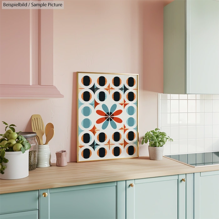 Colorful geometric artwork on kitchen counter with pastel cabinets and plants.