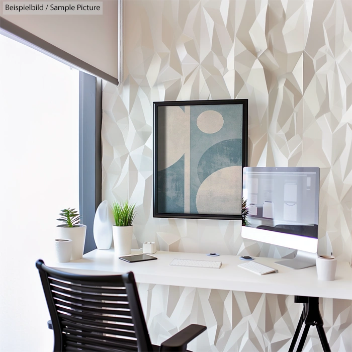 Modern office desk with computer, plant decor, abstract wall art, and geometric wall design.