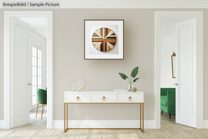 Minimalist living room with white console table, abstract artwork, and green armchair in adjacent room.