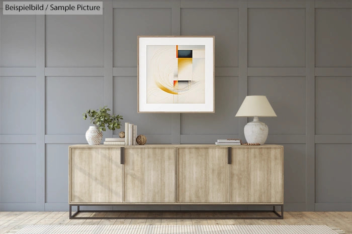 Modern room with wooden sideboard, abstract painting, table lamp, and potted plant against gray paneled wall.