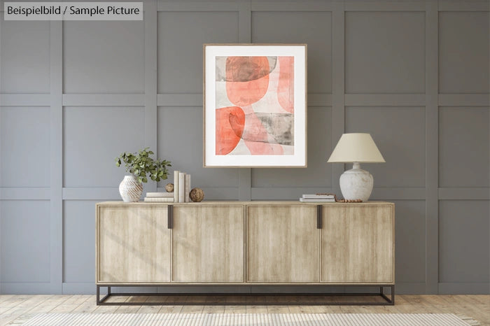 Modern living room with wooden sideboard, abstract painting, and neutral decor accents against gray paneled wall.