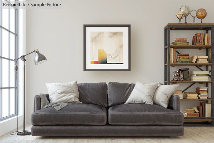 Modern living room with gray sofa, abstract art, and bookshelf with decor and books.