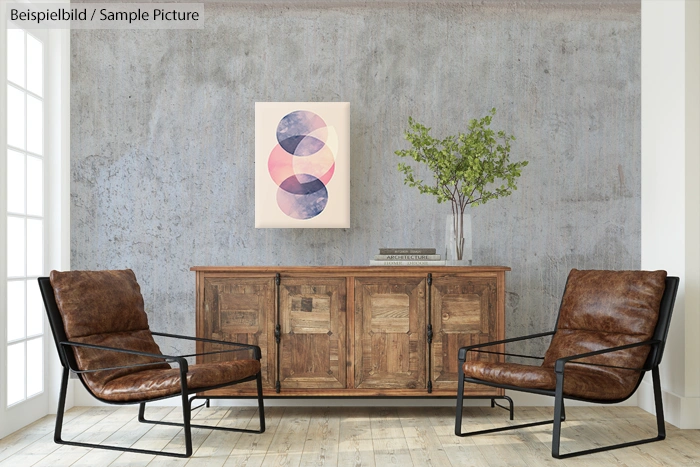 Modern living room with leather chairs, wooden sideboard, abstract artwork, and a plant.