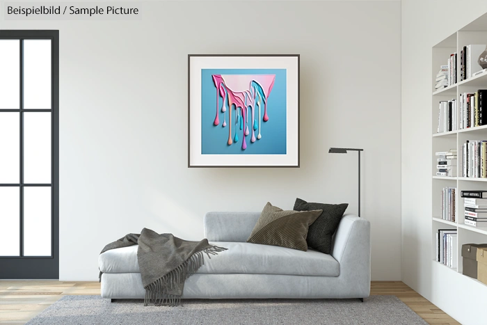 Modern living room with gray sofa, abstract pink art on wall, and bookshelf.