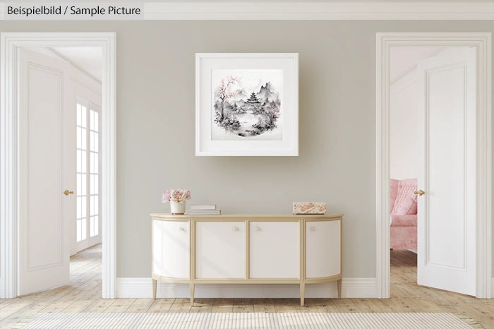 Elegant room with white sideboard and framed monochrome landscape art on wall, light beige decor, and wooden flooring.