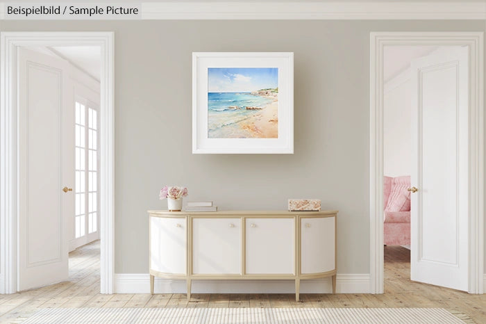 Elegant living room with a beach painting, white sideboard, floral decor, and sunlit doorways on either side.