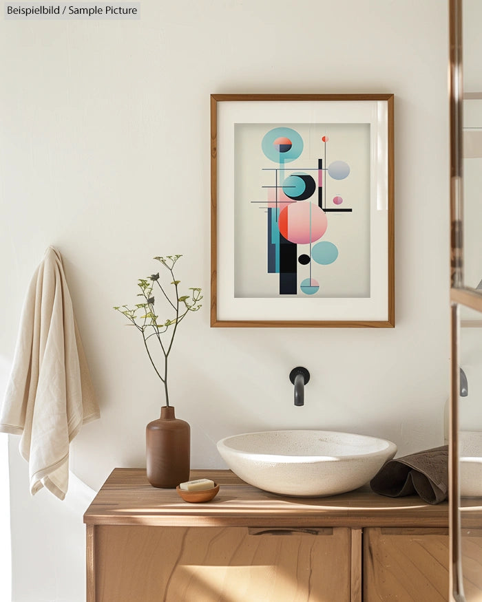 Modern bathroom with abstract art, wooden vanity, vessel sink, and black faucet. Minimal decor with a potted plant.