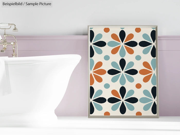 Framed abstract floral artwork with multicolored petals against bathroom wall near white bathtub.