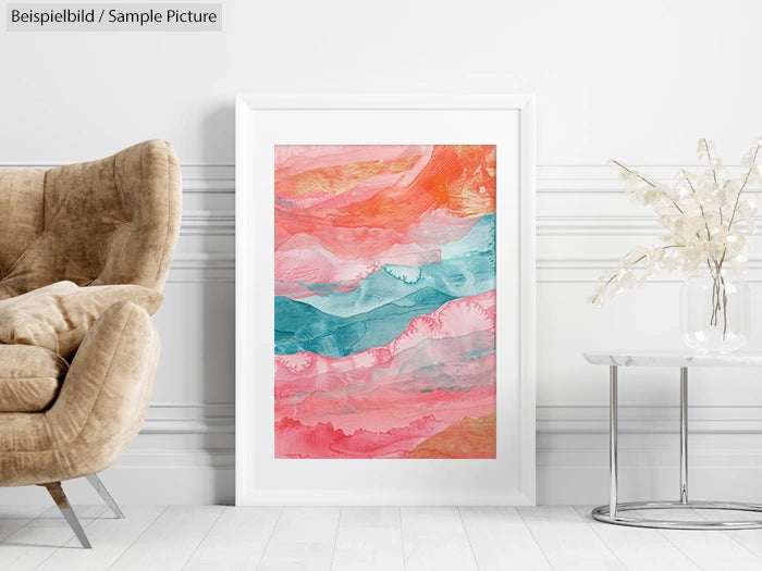 Framed abstract painting in warm tones with waves of pink, orange, and teal, displayed on a white wall next to an armchair.