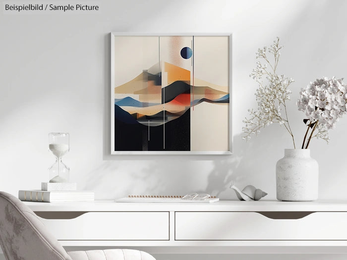 Modern abstract landscape painting on a white wall above a minimalist desk with decorative vases and an hourglass.