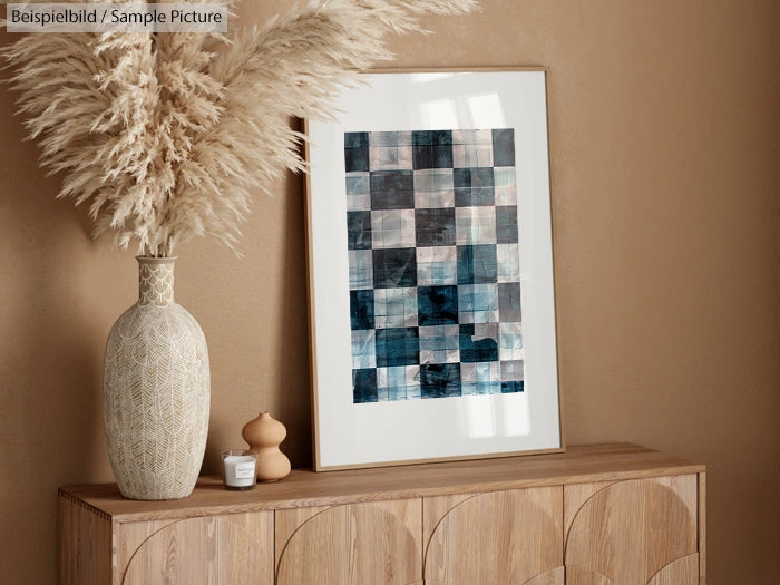 Beige room with framed abstract artwork, pampas grass vase on wooden cabinet, modern and minimalist decor.