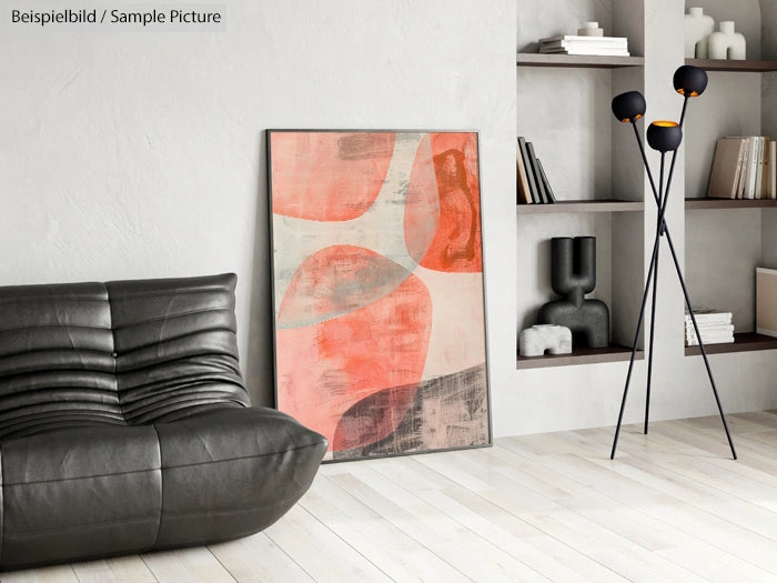 Modern living room with abstract orange and beige painting, black sofa, tripod lamp, and decorative shelves.