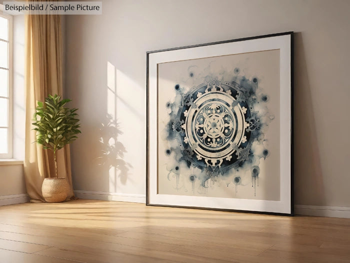 Modern mandala art framed and placed on wooden floor near a potted plant in a well-lit room.