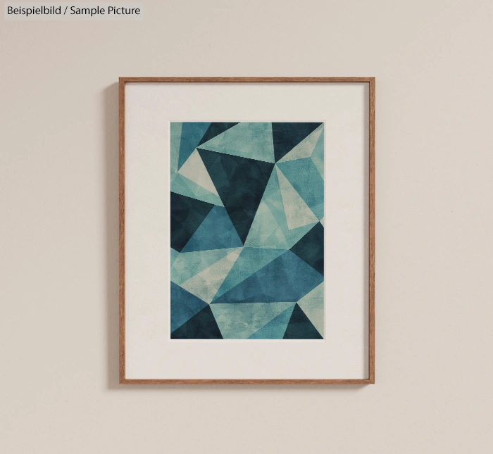 Framed geometric abstract artwork with shades of blue and teal triangles on a beige wall.