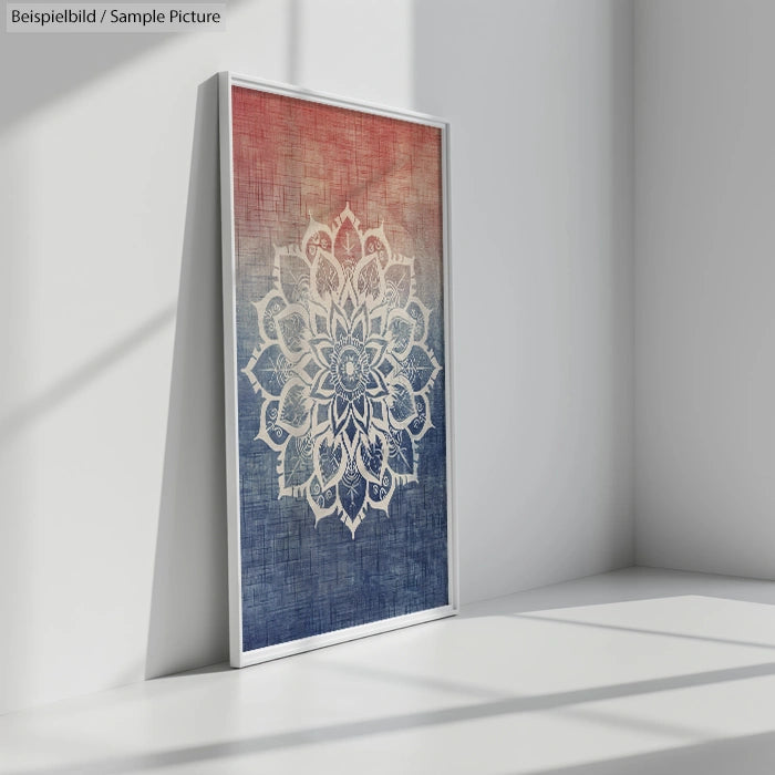 Framed mandala artwork with red to blue gradient, leaning against a white wall in a bright lit room.