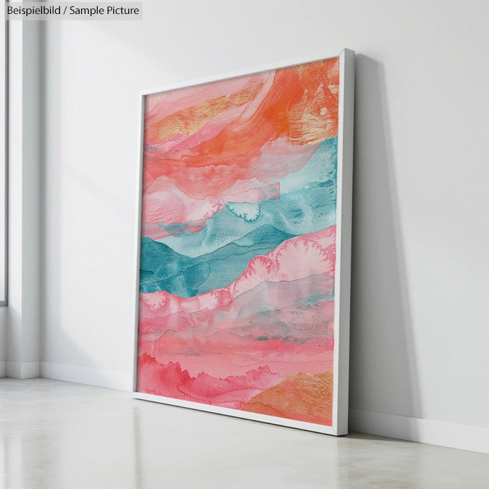 Framed abstract painting with vibrant swirls of orange, pink, and teal, leaning against a white wall.