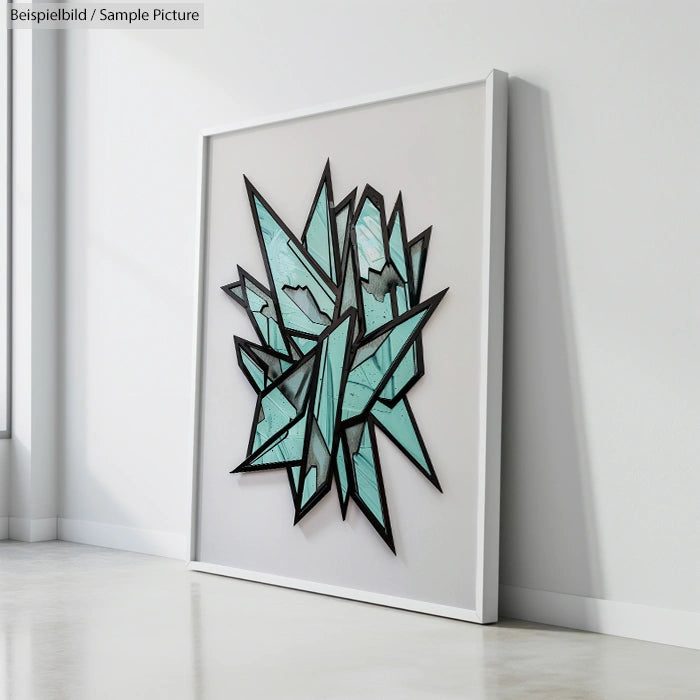 Framed abstract wall art with geometric, shattered glass design in teal and black against a white background.