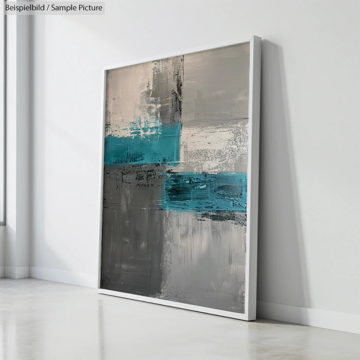 Abstract painting with teal, gray, and beige blocks, leaning against a white wall in a minimalist room.