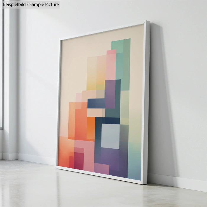 Framed artwork with a geometric pattern of colorful rectangles leaning against a white wall.