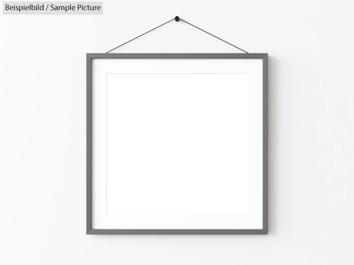 Minimalist picture frame hanging on a wall with a blank grayscale square artwork inside.