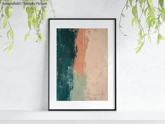 Framed abstract painting with dark green and beige tones, hung on a white wall with hanging plants.