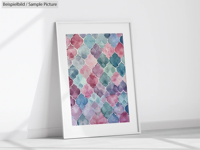 Framed abstract artwork with colorful geometric shapes leaning against a white wall on a light floor.