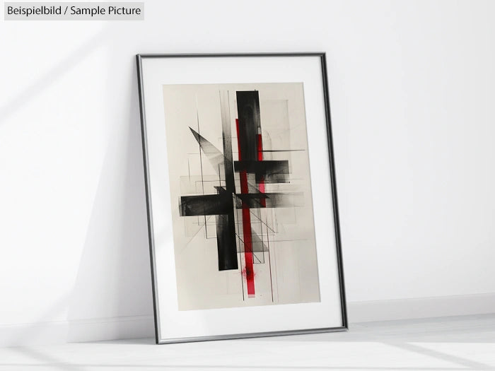 Abstract framed artwork with black and red geometric shapes on a beige background, leaning against a white wall.