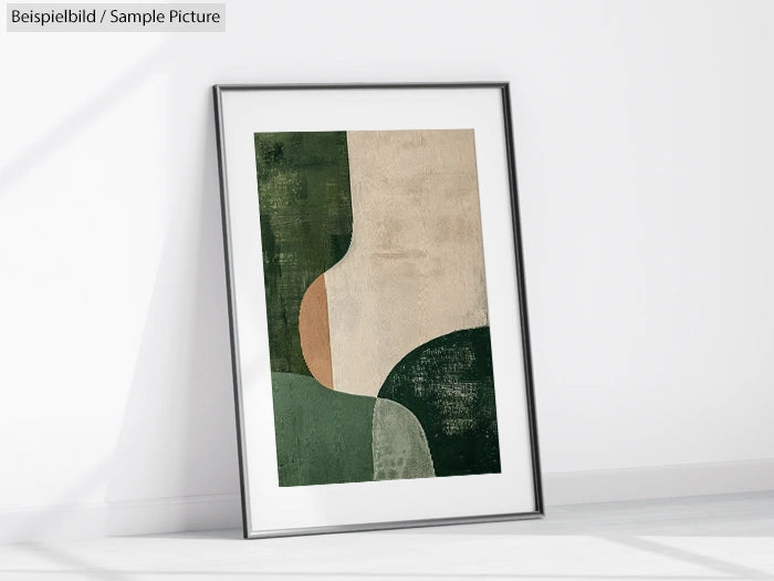 Framed abstract painting with green and beige curved shapes, leaning against a white wall on a light floor.