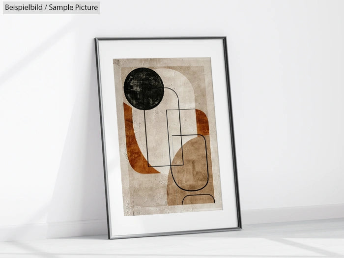 Framed abstract art with geometric shapes and earth tones, placed on a white surface.