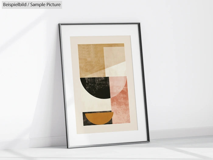 Framed abstract geometric art print with overlapping shapes in earth tones against a white wall.