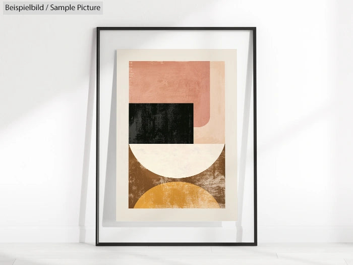 Framed abstract art with geometric shapes in pink, black, beige, and brown against a white wall.