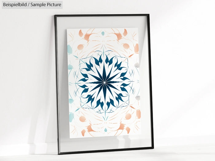 Framed geometric art print with symmetrical blue and beige design against a white wall.