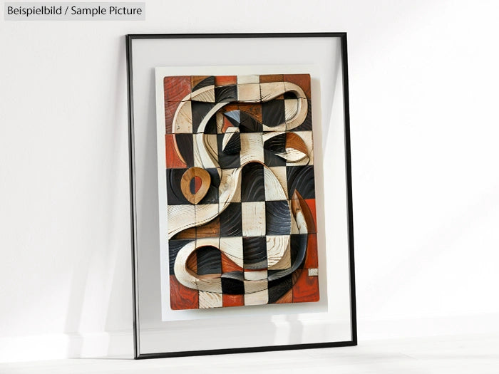 Framed abstract wooden artwork with snake motif, featuring black, white, and brown tones, leaning against a wall.