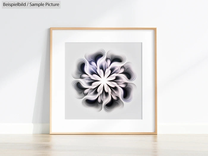 Framed abstract art with swirling black and white pattern displayed on a light-colored floor against a plain wall.